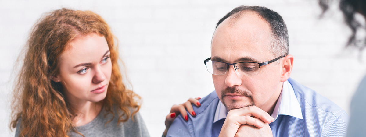  Supportive wife comforting husband with TRD during a meeting with a counselor in Yorktown Heights.