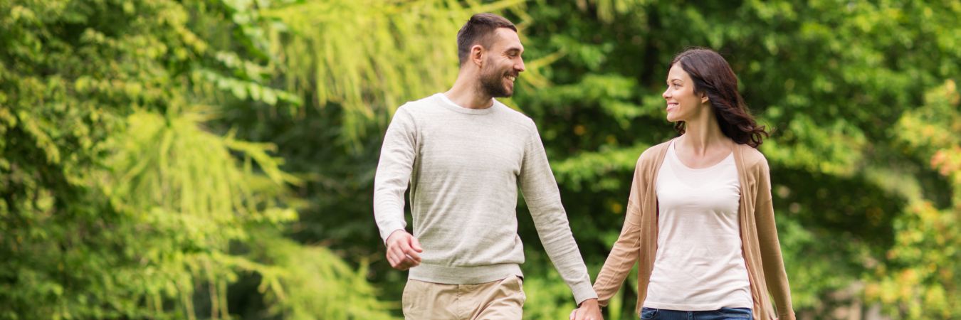 A couple walking hand in hand at a park during summer season enjoying life after rehab in Yorktown Heights
